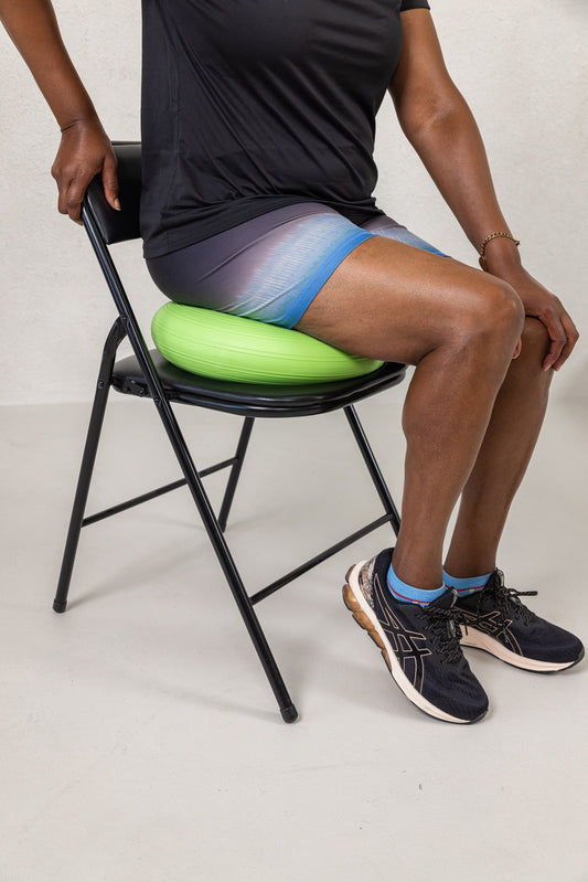 A women completing active sitting with a stability cushion