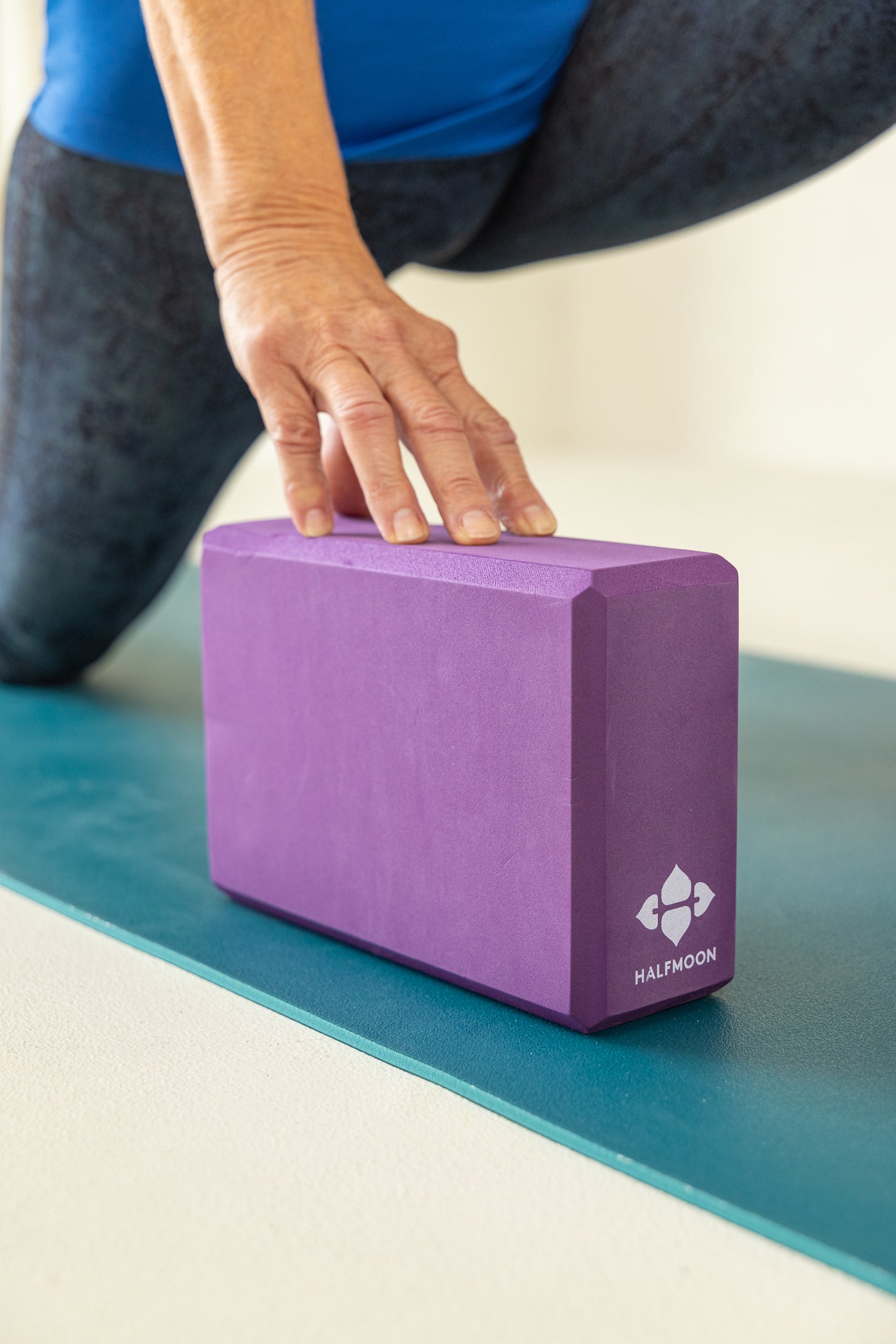 senior woman stretching yoga block